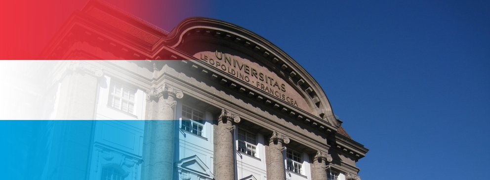 Foto vom Universitäts Hauptgebäude mit Farbverlauf der Luxemburgischen Flagge